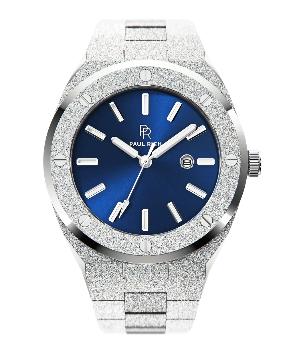 Front view of Paul Rich frosted silver watch with metallic blue sunray dial, silver markers, and date window, on transparent background.