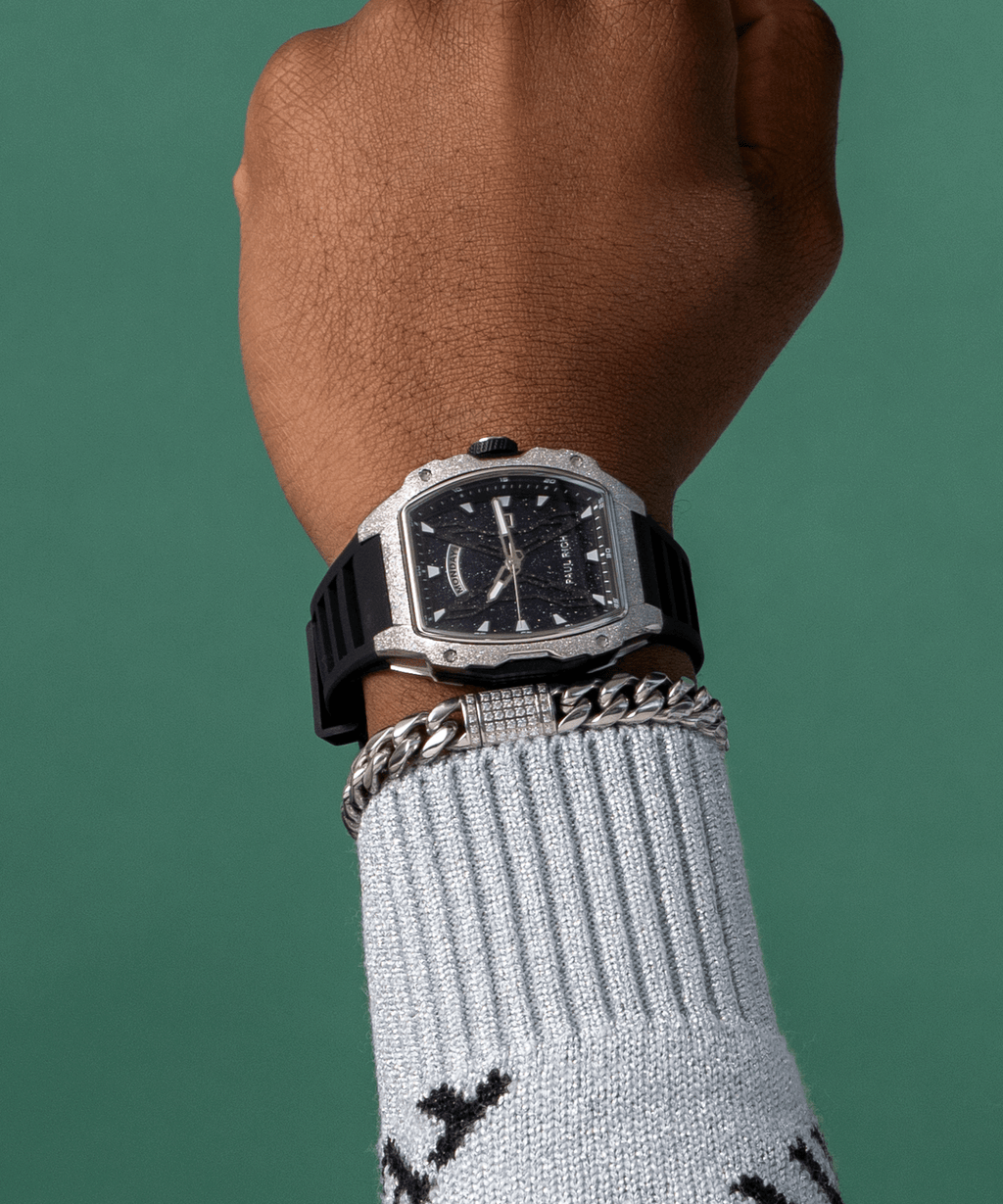 Paul Rich watch with blue aventurine dial and silver frosted bezel worn on wrist, paired with silver bracelet and light blue sweater.