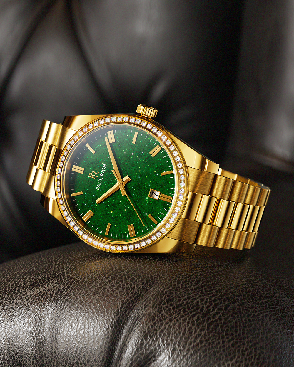 Gold-tone Paul Rich watch with green aventurine dial, diamond-set bezel, and gold link bracelet, displayed resting on a dark brown leather cushion.