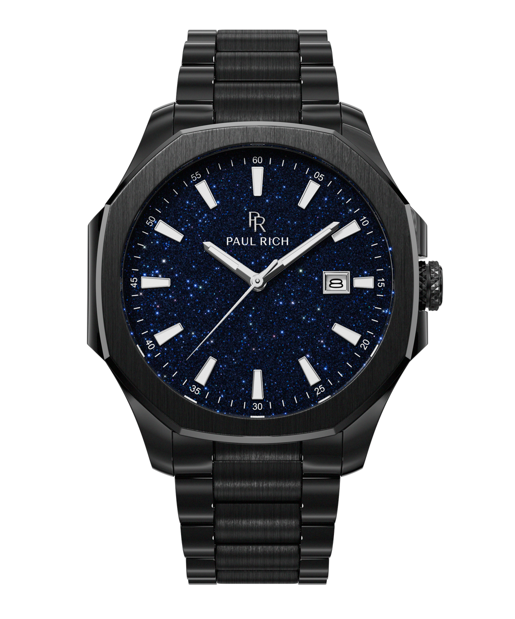 Front view of Paul Rich watch with brushed black case and bracelet, blue aventurine dial, silver indices, and date window at 3 o’clock.