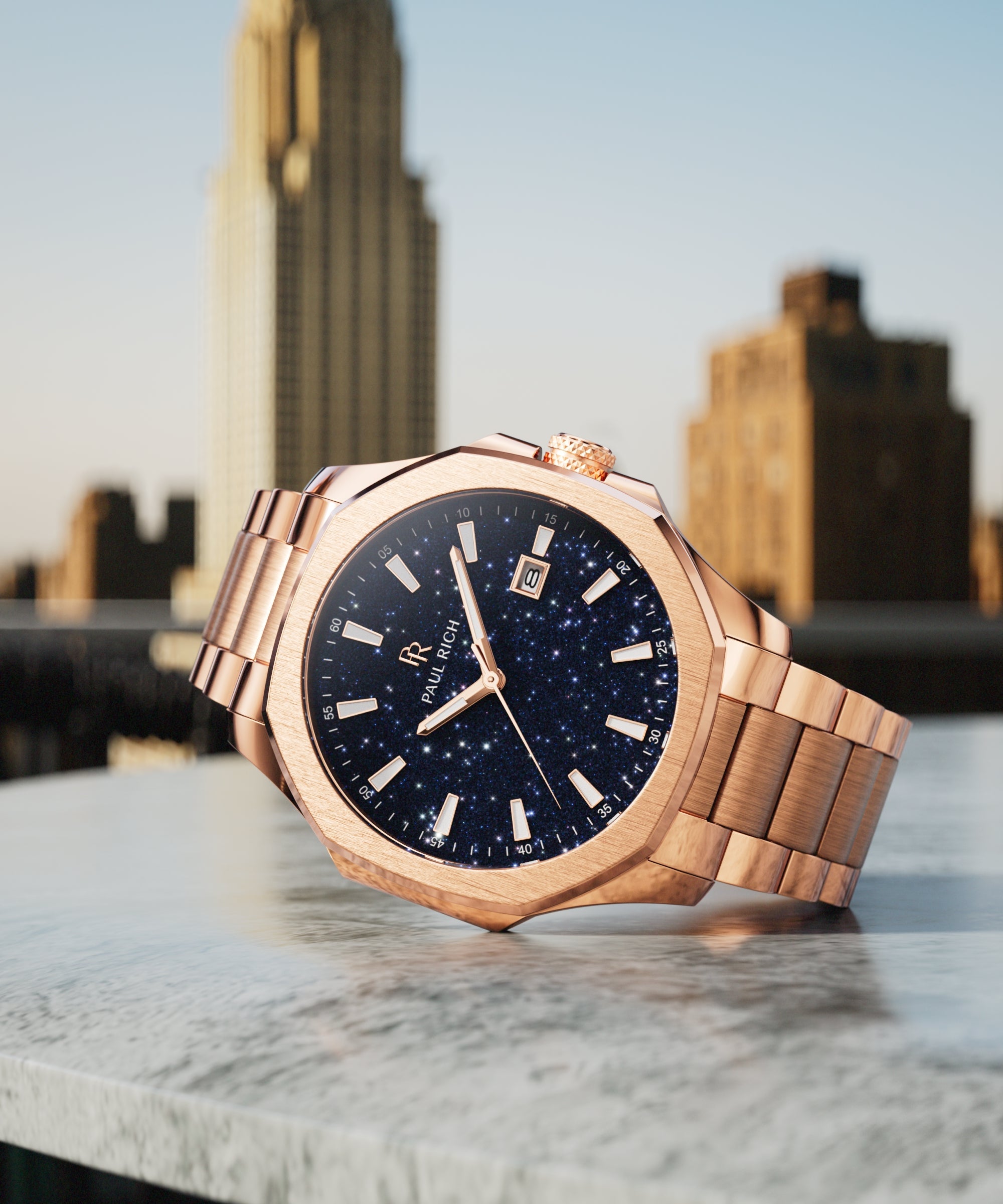 Paul Rich watch with brushed rose gold case and blue aventurine dial displayed on rooftop ledge with the Chrysler Building in background.
