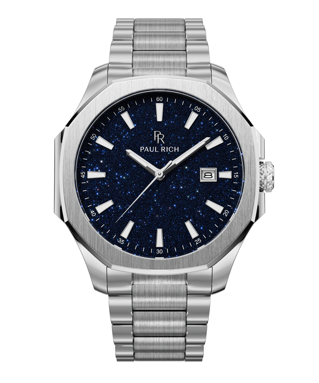 Front view of Paul Rich watch with brushed silver case and bracelet, blue aventurine dial, silver indices, and date window at 3 o’clock.