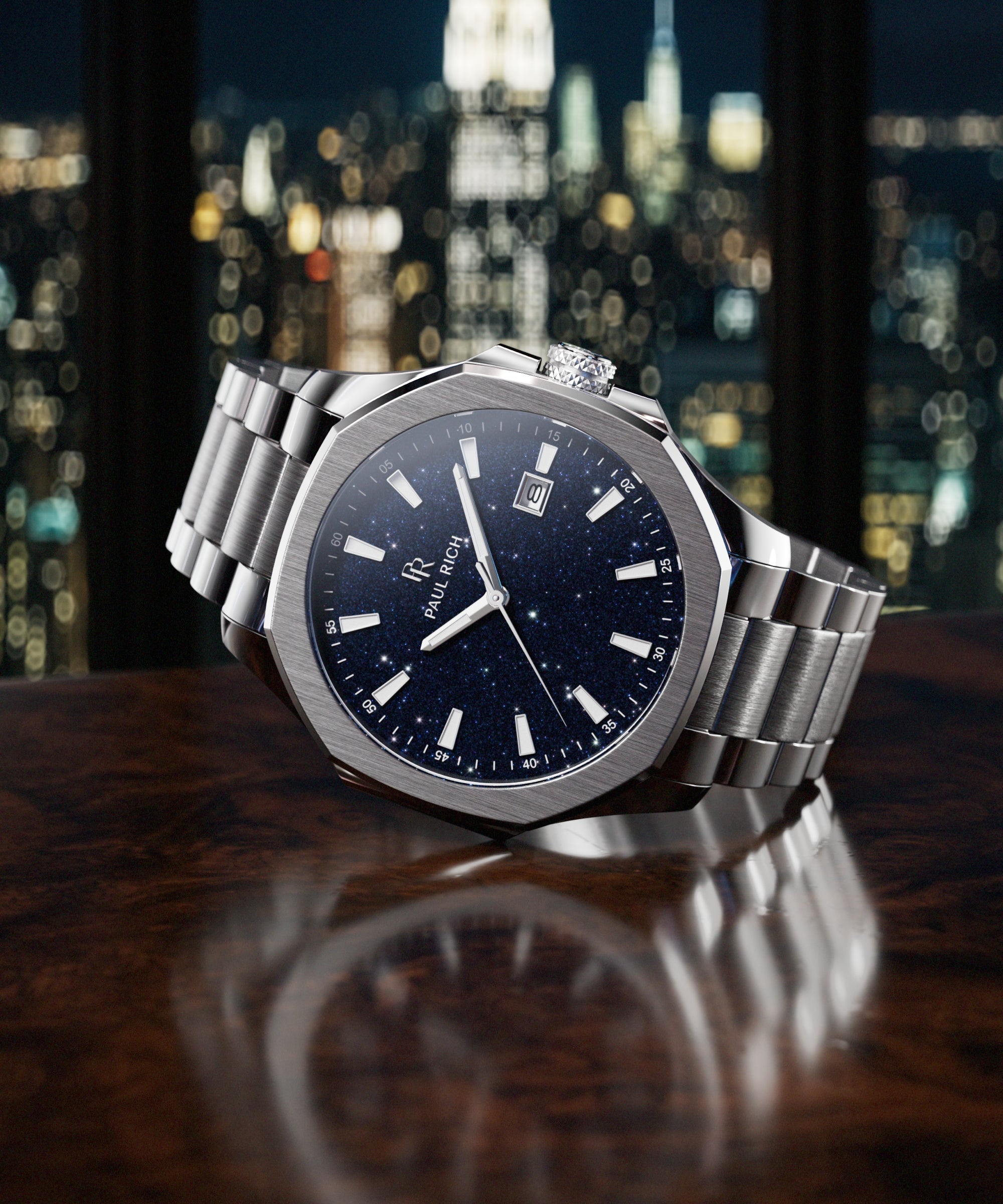 Paul Rich watch with brushed silver case and blue aventurine dial resting on dark wood surface, with NYC skyline at night in background.