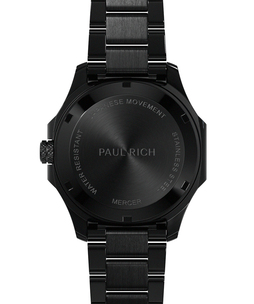 Back view of Paul Rich watch with brushed black caseback engraved with “PAUL RICH,” “MERCER,” “JAPANESE MOVEMENT,” and “STAINLESS STEEL.”