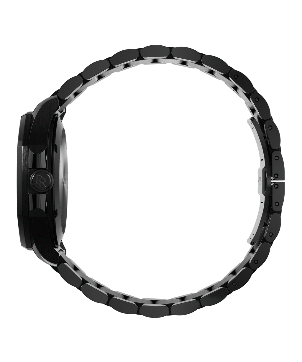 Side view of Paul Rich watch with brushed black case, PR monogram crown, and closed black metal bracelet forming a circular loop.