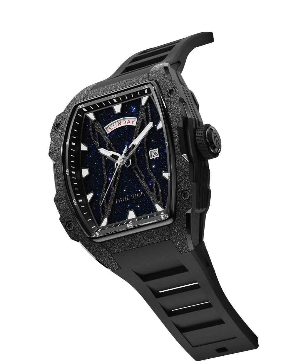 Angled view of Paul Rich watch with blue aventurine dial, frosted bezel, PR monogram crown, day-date display, and black rubber strap.