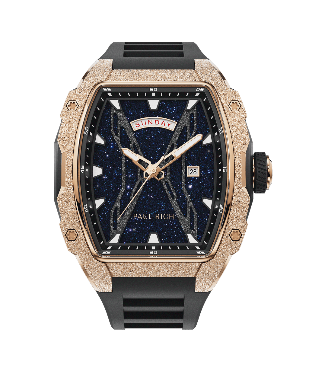 Paul Rich watch with frosted rose gold tonneau case, black rubber strap, blue aventurine dial, day-date display, and bold white hour markers.