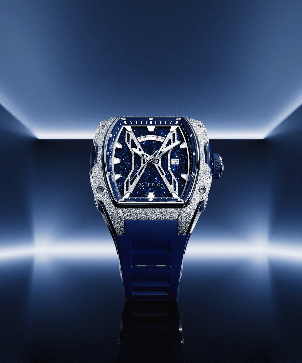 Paul Rich watch with blue aventurine dial, silver frosted bezel, and blue strap, displayed in neon blue-lit environment.