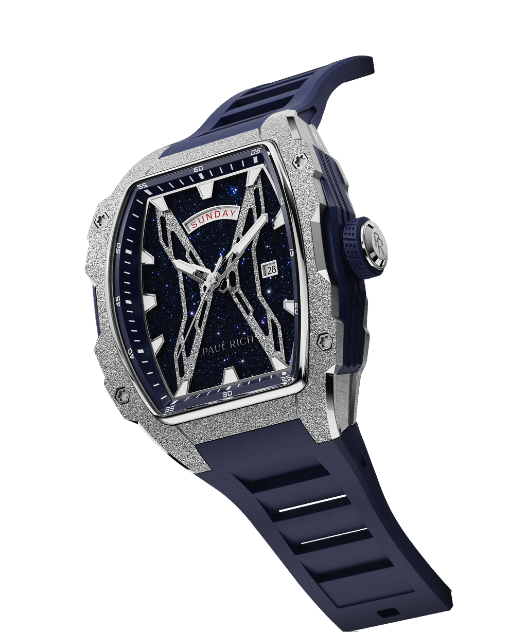 Angled view of Paul Rich watch with blue aventurine dial, silver frosted bezel, PR monogram crown, and matching blue rubber strap.