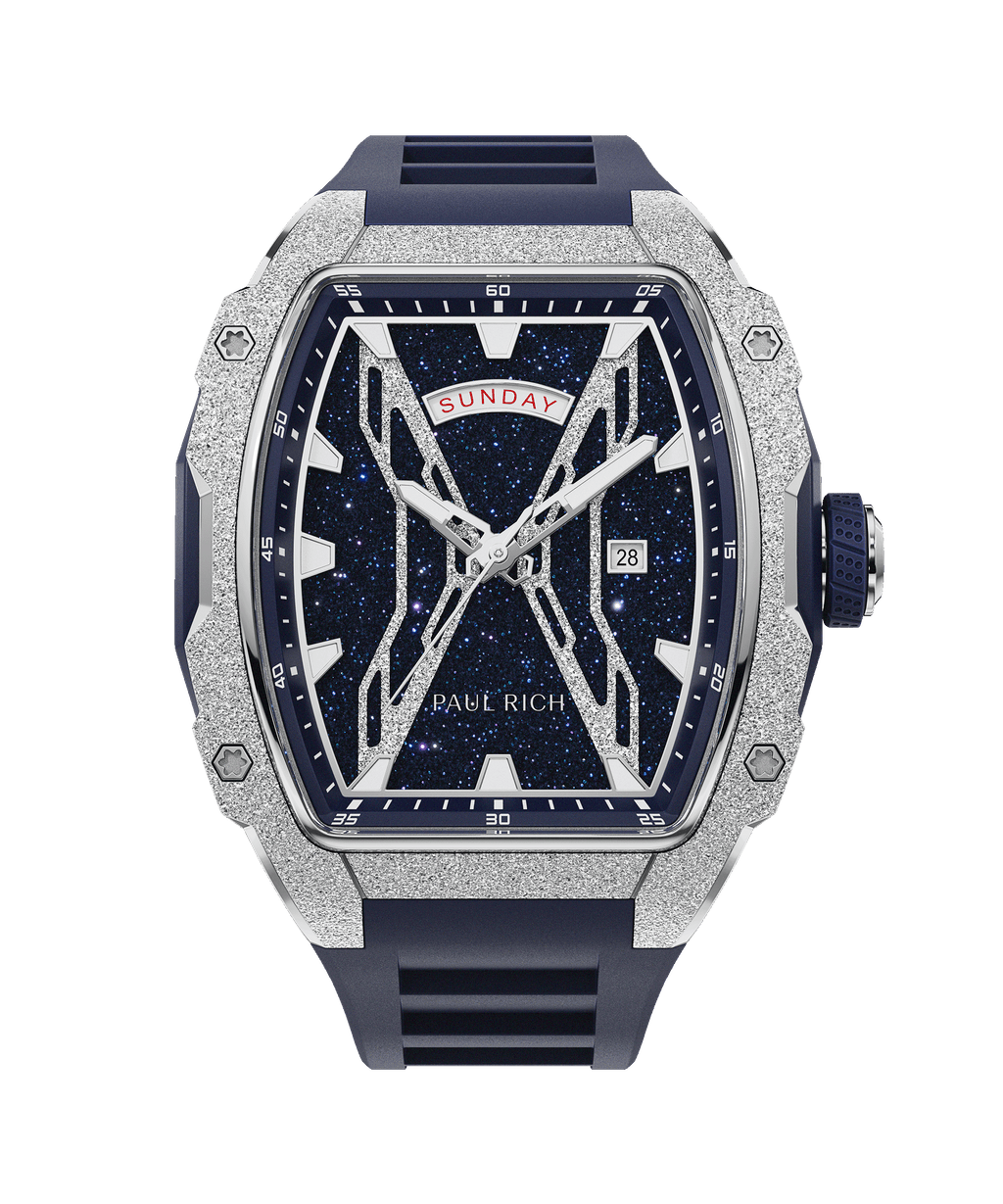 Front view of Paul Rich watch with blue aventurine dial, silver frosted bezel, day-date display, and matching blue rubber strap.