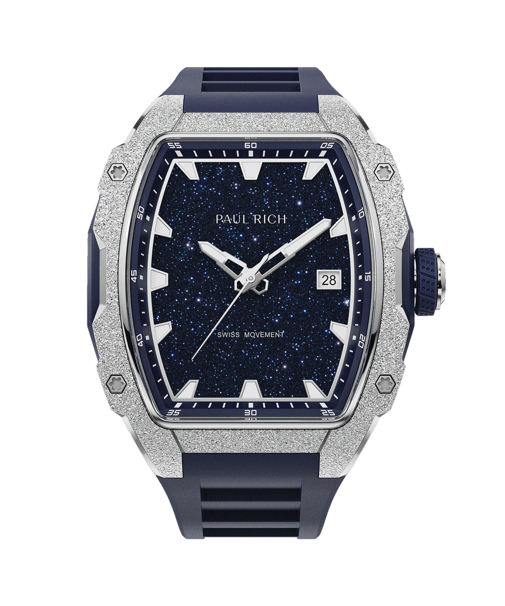 Paul Rich watch with frosted silver bezel, blue aventurine dial, date window, and blue rubber strap, in a tonneau-shaped case.