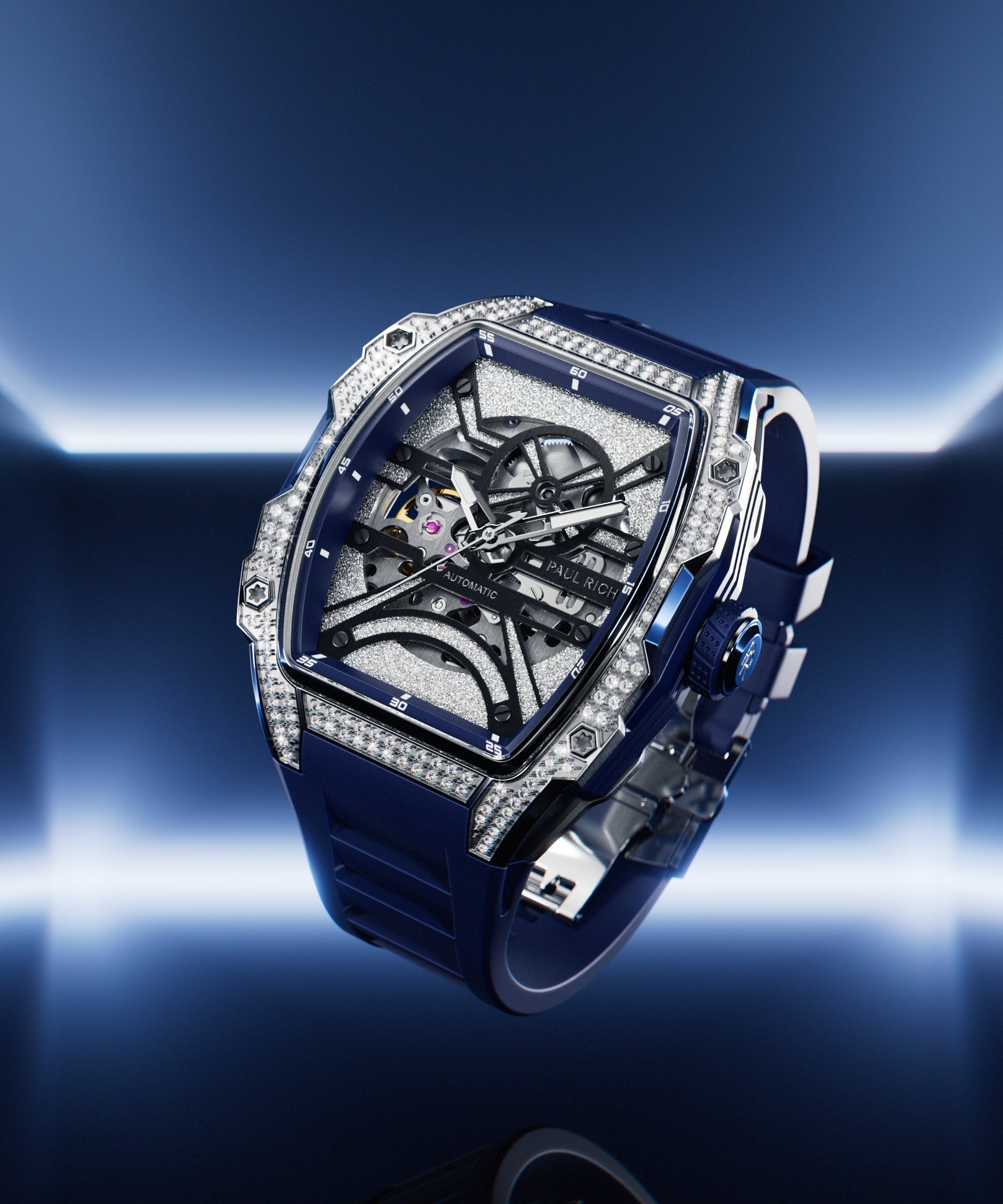 Angled view of open dial watch with diamond-set silver case and blue strap, shown on glowing blue gradient background.