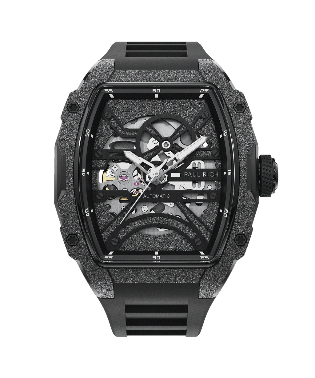 Paul Rich watch with frosted black tonneau case, silver skeleton dial, white hands, and black rubber strap, shown on transparent background.