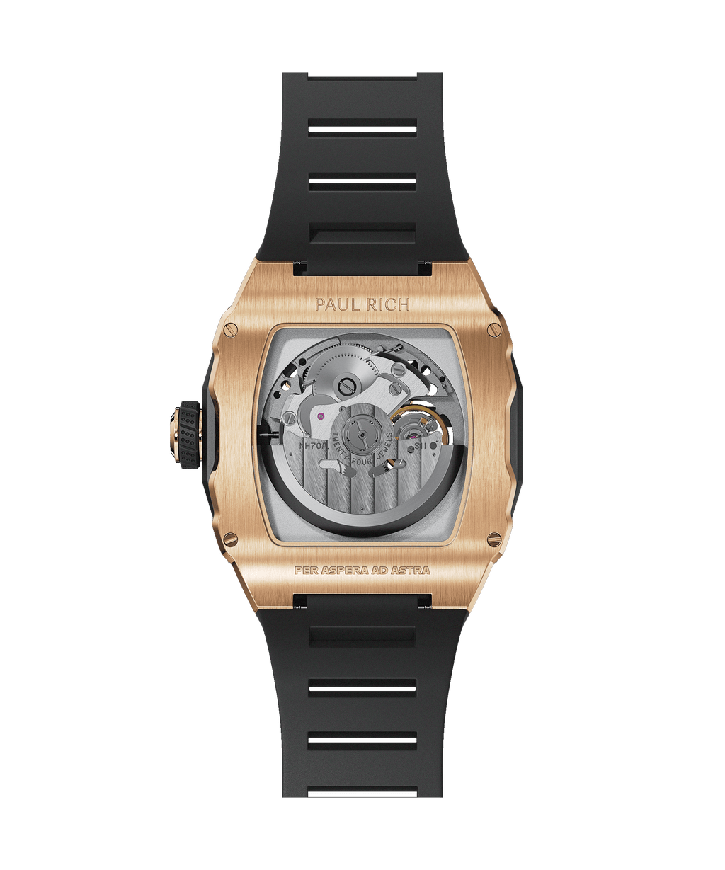 Back view of Paul Rich watch with rose gold case, exposed automatic movement, and black rubber strap, engraved with ‘Per Aspera Ad Astra.’