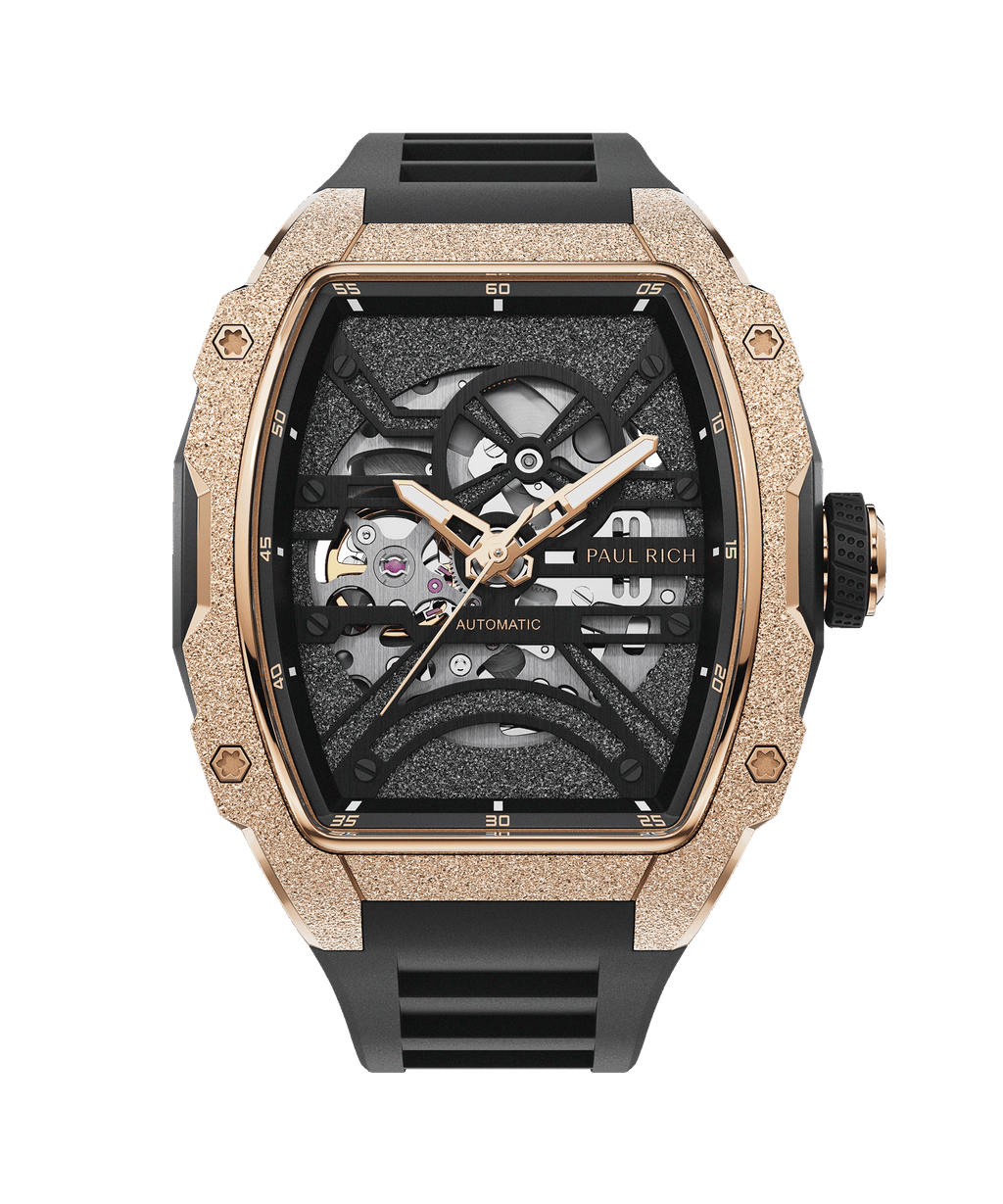 Paul Rich watch with frosted rose gold tonneau case, skeleton dial, and black rubber strap, displayed on transparent background.