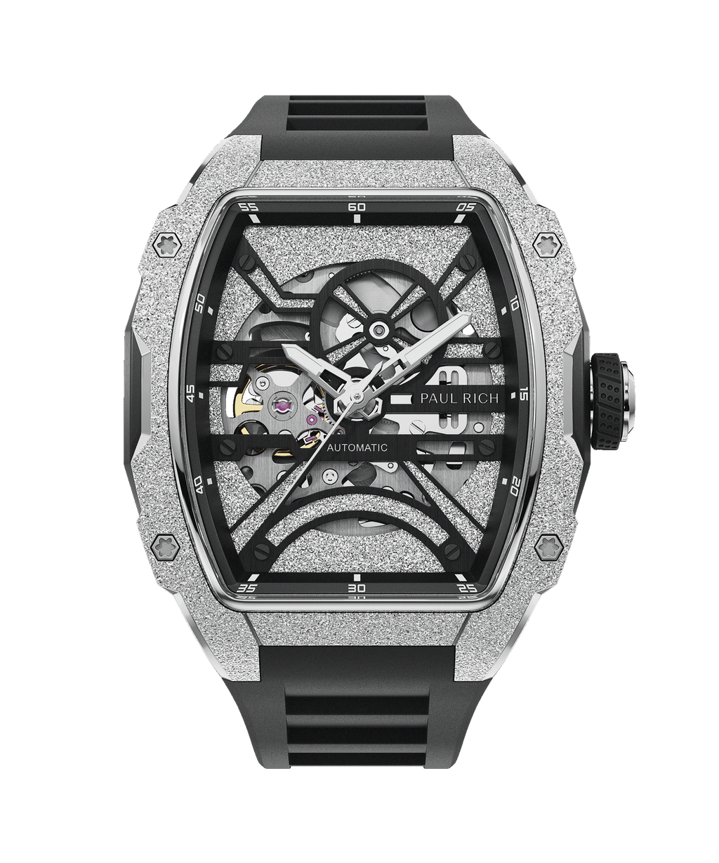 A close-up of the Paul Rich Group LLC Astro Skeleton Abyss Silver watch, featuring a textured silver-toned case, transparent skeleton dial revealing inner workings, and black strap set against a black backdrop.