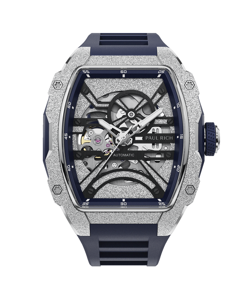 Paul Rich watch with frosted silver tonneau case, skeleton dial, white hands, and blue rubber strap, shown on transparent background.