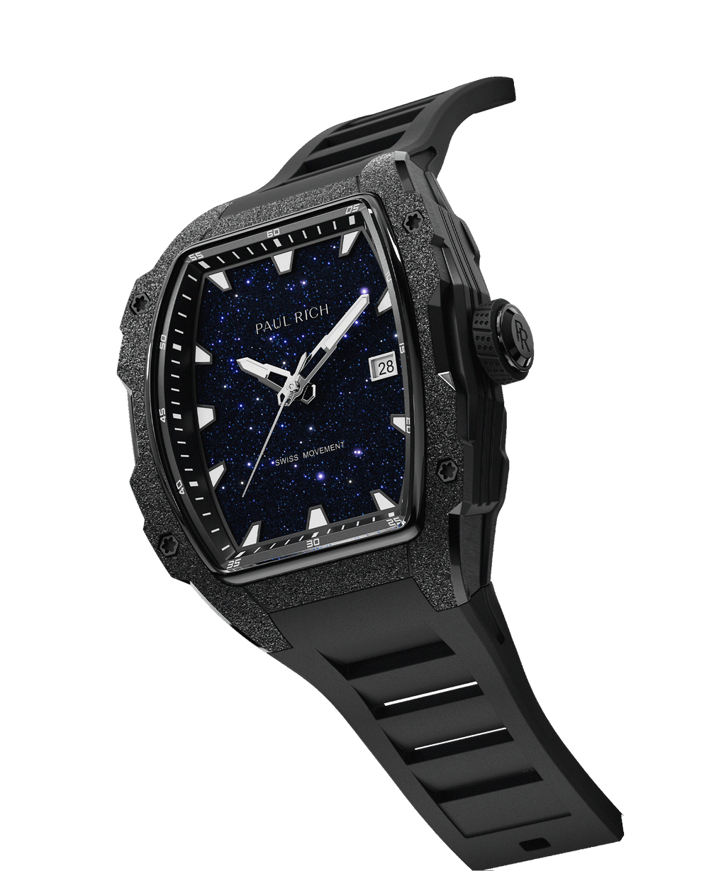 Angled view of tonneau-shaped Paul Rich watch with blue aventurine dial, black frosted bezel, PR crown, and black rubber strap.