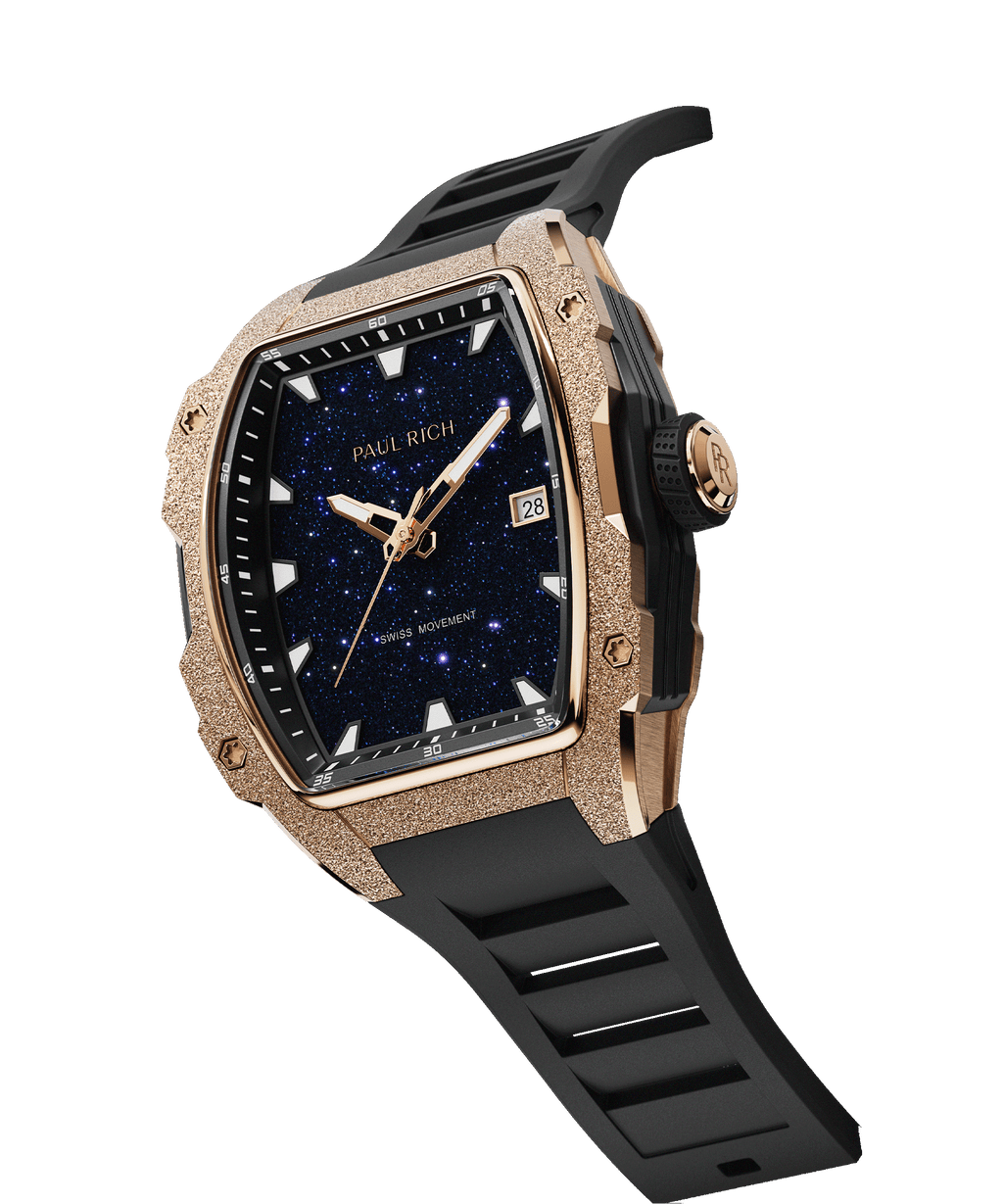 Angled view of Paul Rich watch with blue aventurine dial, rose gold frosted bezel, PR monogram crown, and black rubber strap.