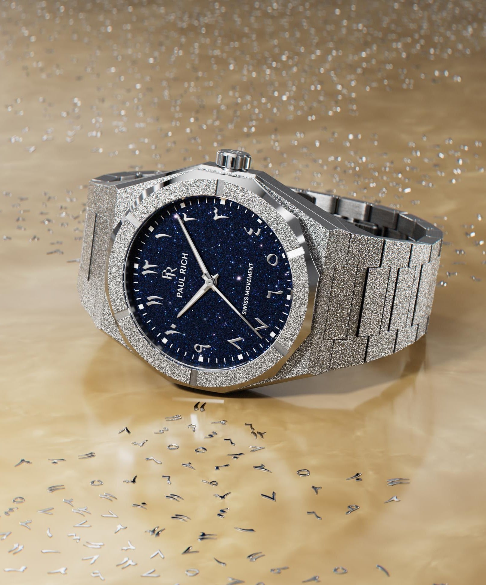 Frosted silver watch with a blue aventurine dial and Arabic numerals, displayed on a reflective ivory surface with scattered metallic markers.