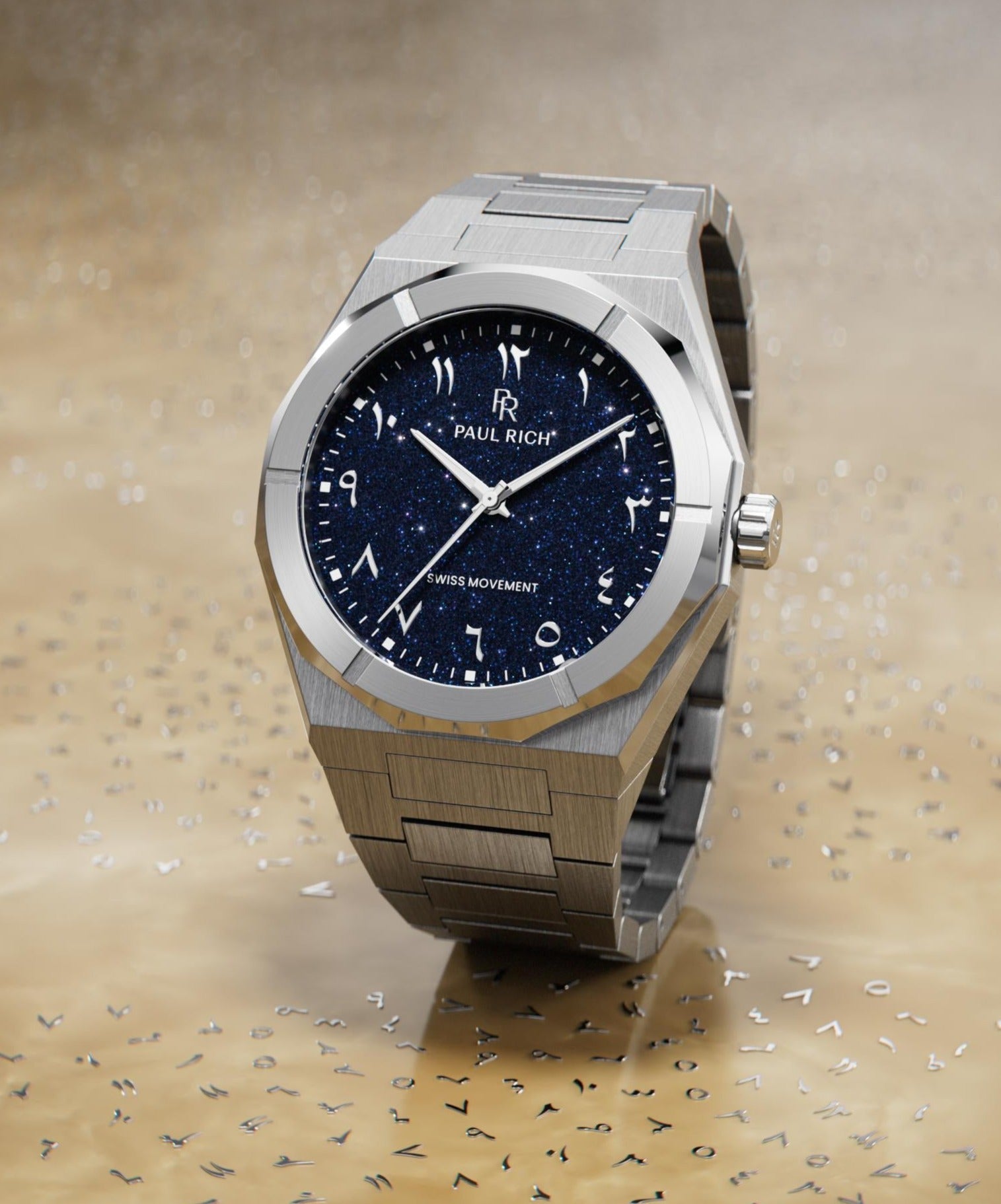 Paul Rich watch with brushed silver case and blue aventurine dial with Arabic numerals, displayed on a reflective gold surface with scattered markers.