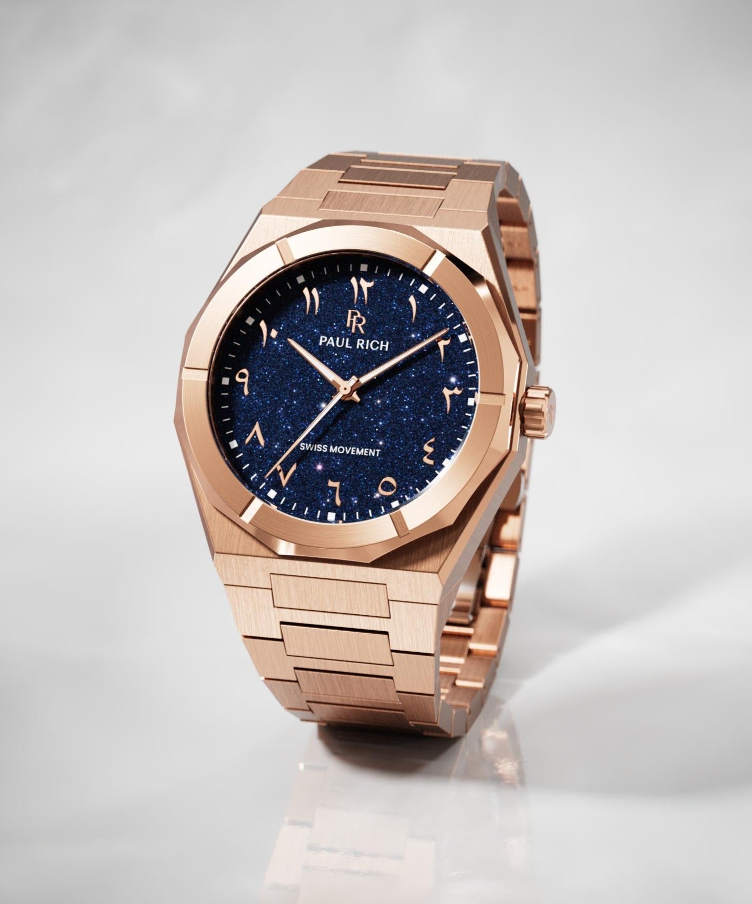 Paul Rich watch with brushed rose gold case and bracelet, featuring a blue aventurine dial with Arabic numerals, displayed on a white surface.