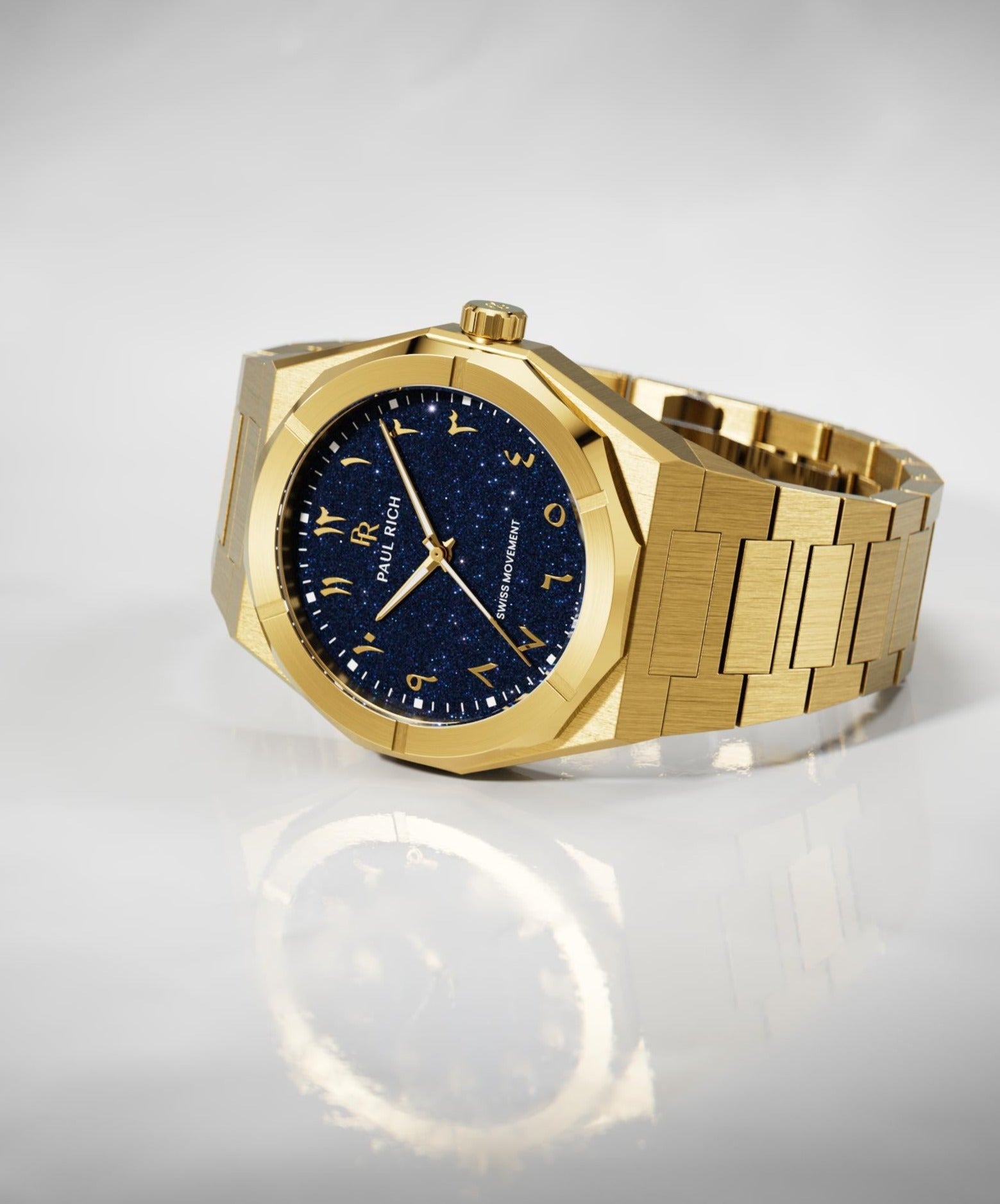 Paul Rich watch with brushed gold case and bracelet, blue aventurine dial with Arabic numerals, displayed on a glossy white surface.