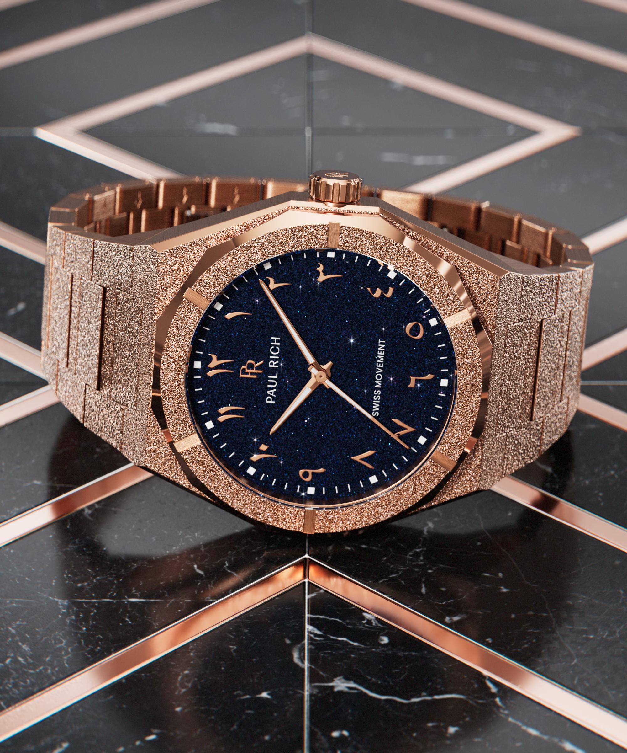 Frosted rose gold watch with a blue aventurine dial and Arabic numerals, laid flat on a glossy black and rose gold geometric surface.