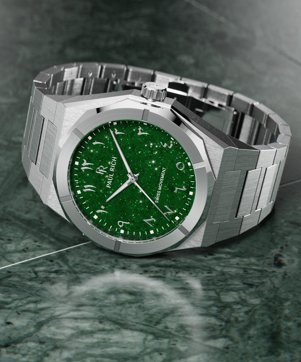 Paul Rich watch with brushed silver case and sparkling green dial with Arabic numerals, displayed on a polished green marble surface.