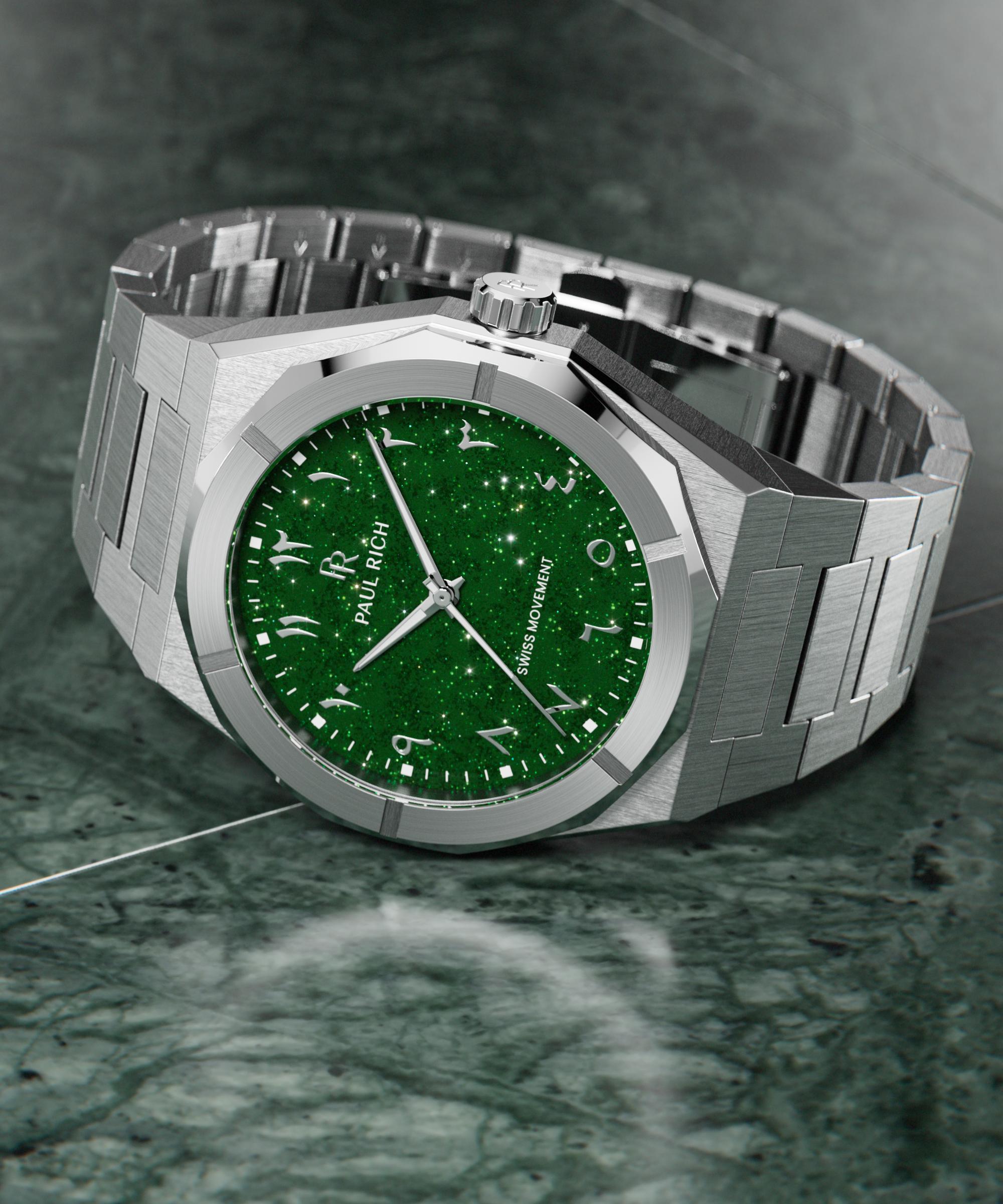 Paul Rich watch with brushed silver case and sparkling green dial with Arabic numerals, displayed on a polished green marble surface.