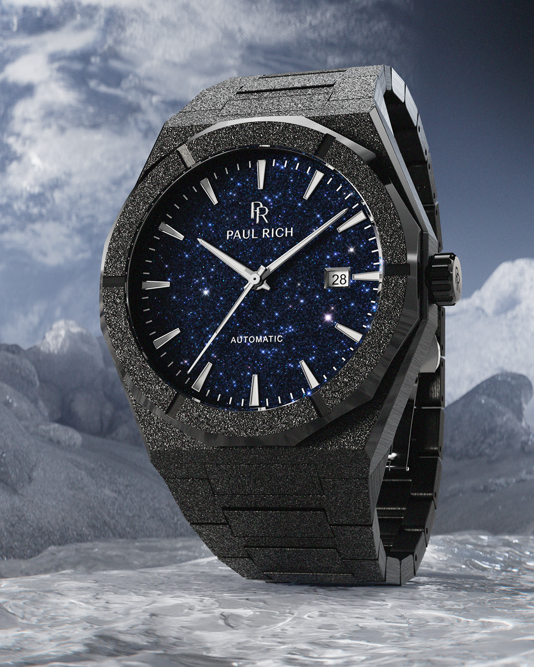Black frosted Paul Rich watch with blue aventurine dial and date window, standing on icy terrain with cloudy mountains in the background.
