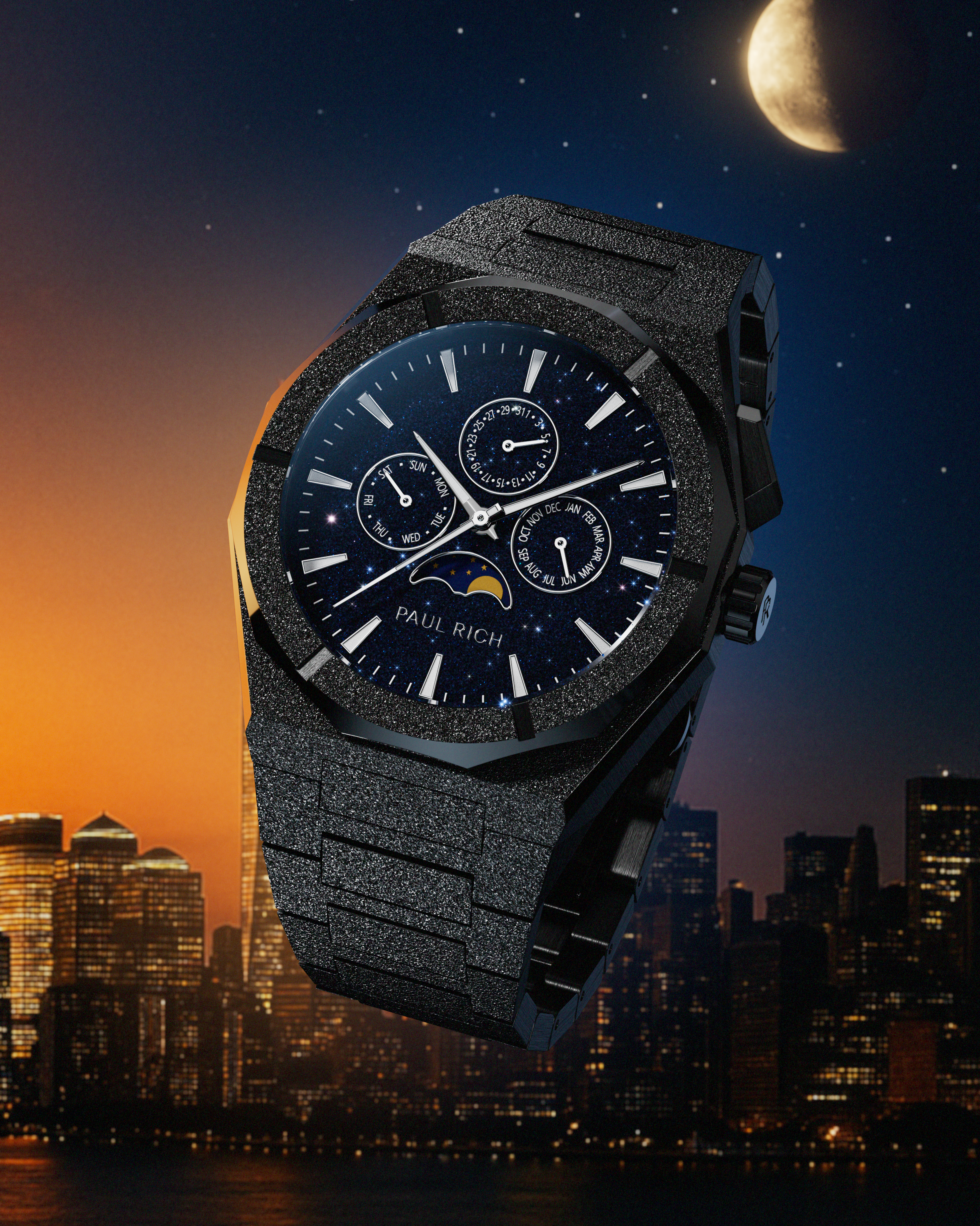 Frosted black stainless steel watch with blue aventurine dial, moonphase, and subdials, set against a city skyline at dusk with a moonlit sky.