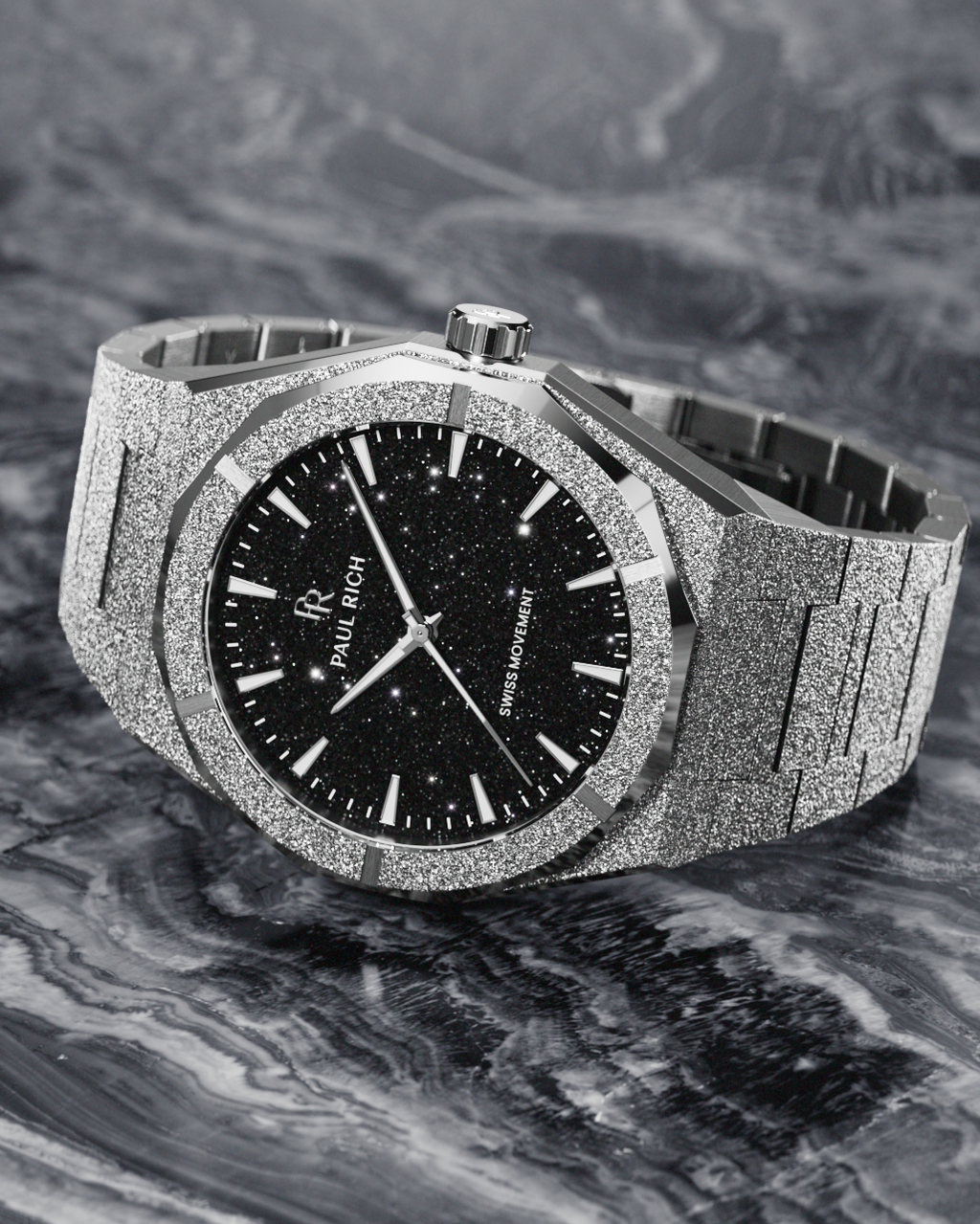 Paul Rich watch with frosted silver case and black aventurine dial, resting on a marbled surface with swirling monochrome texture.