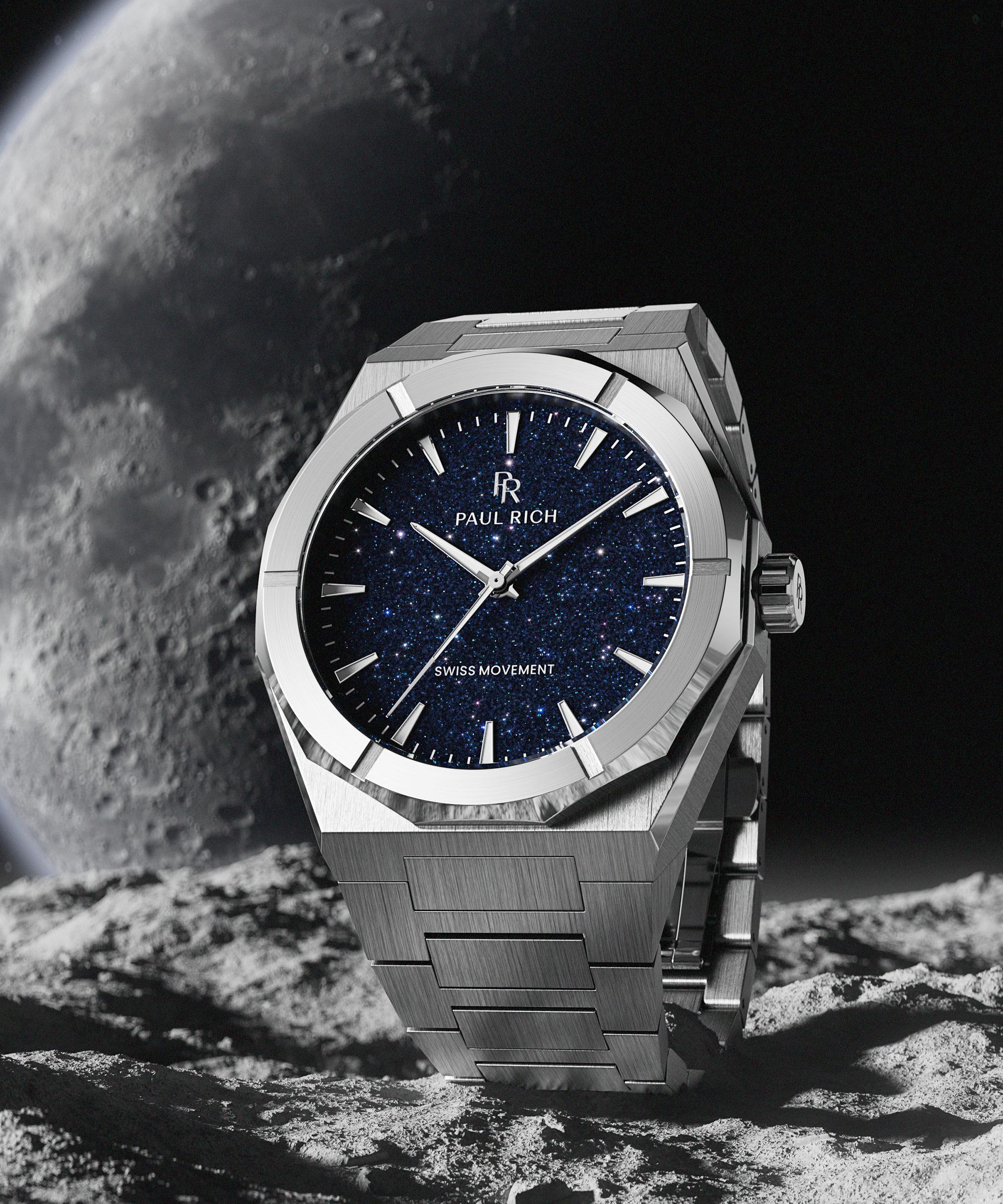 Silver Paul Rich watch with blue aventurine dial placed on rocky surface, with moon and space background evoking a lunar setting.