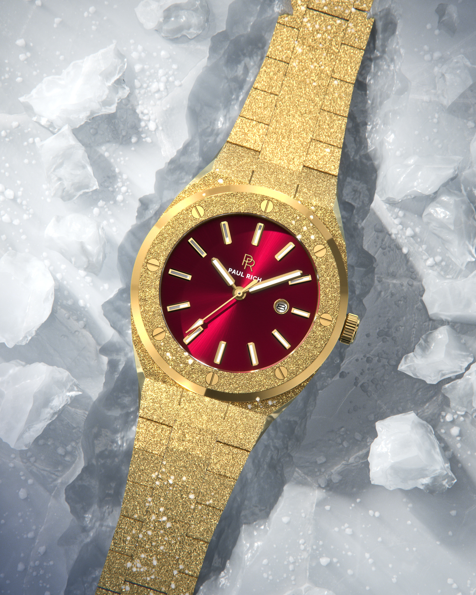 Paul Rich watch with frosted gold case and bracelet, metallic red sunray dial, and date window, displayed on a surface covered with translucent ice shards.