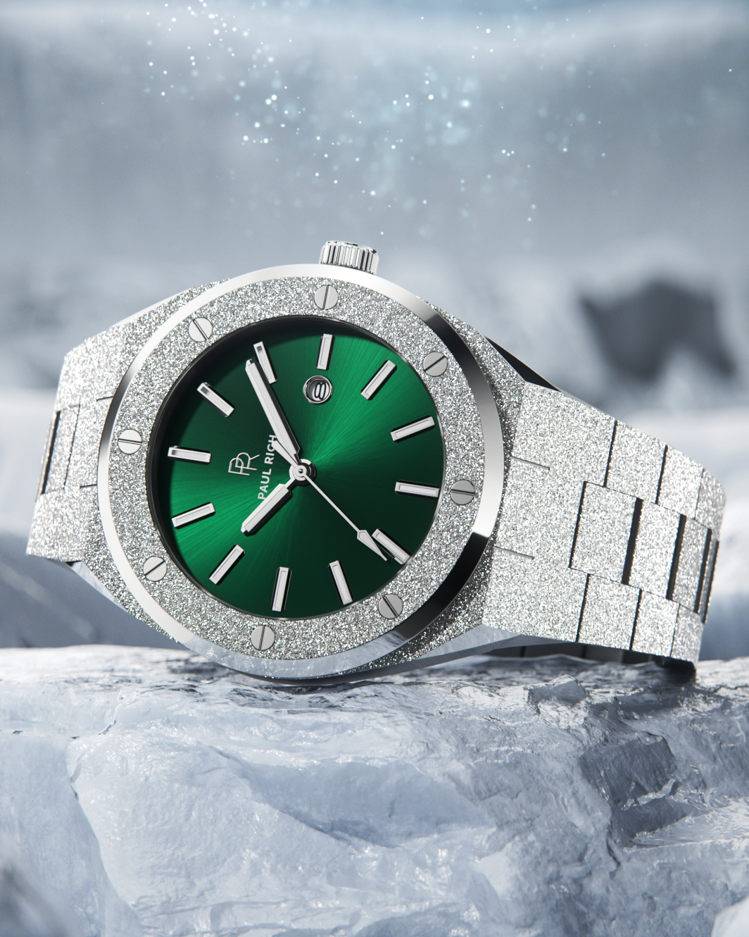 Paul Rich frosted silver watch with green sunray dial and silver markers, resting on icy rock with snow and sparkles in the background.
