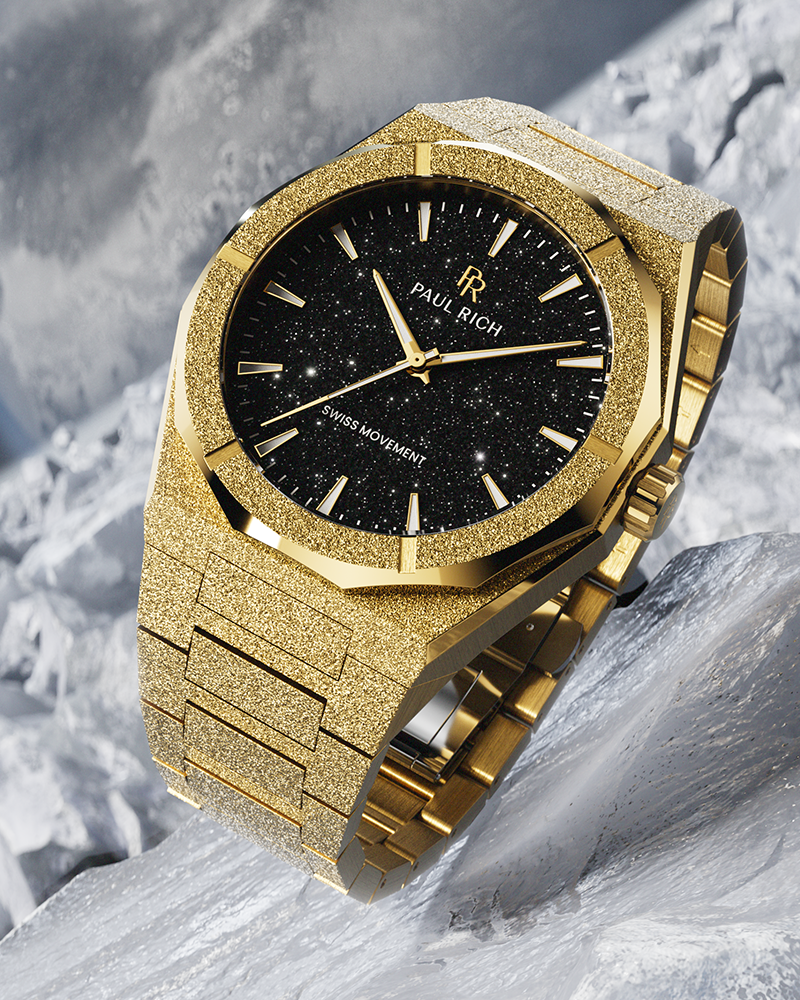 Gold Paul Rich watch with frosted finish and black aventurine dial, displayed on a textured icy surface with dramatic lighting.