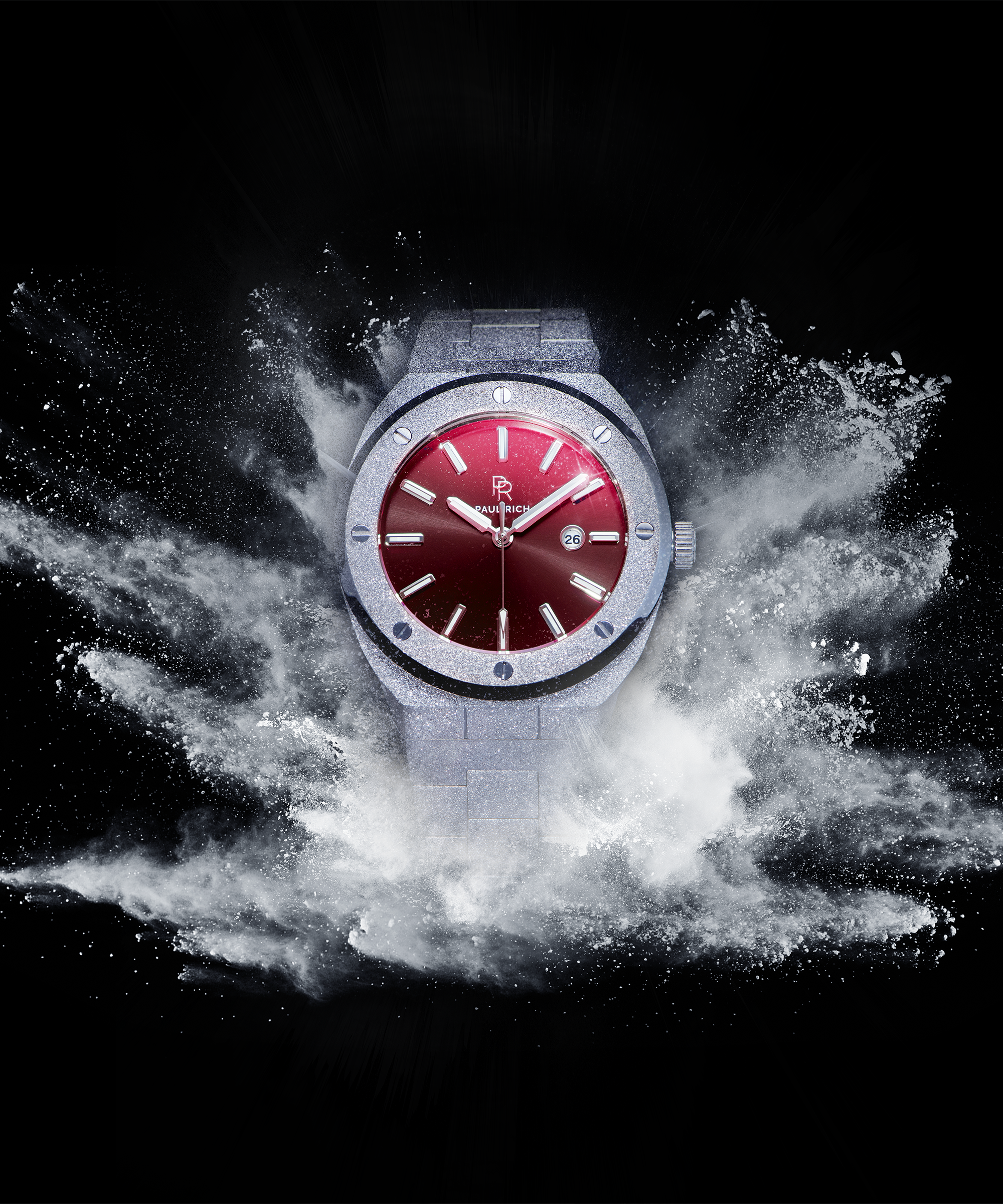 Paul Rich watch with round frosted silver case and red sunray dial, displayed against a black background with white powder explosion effect.