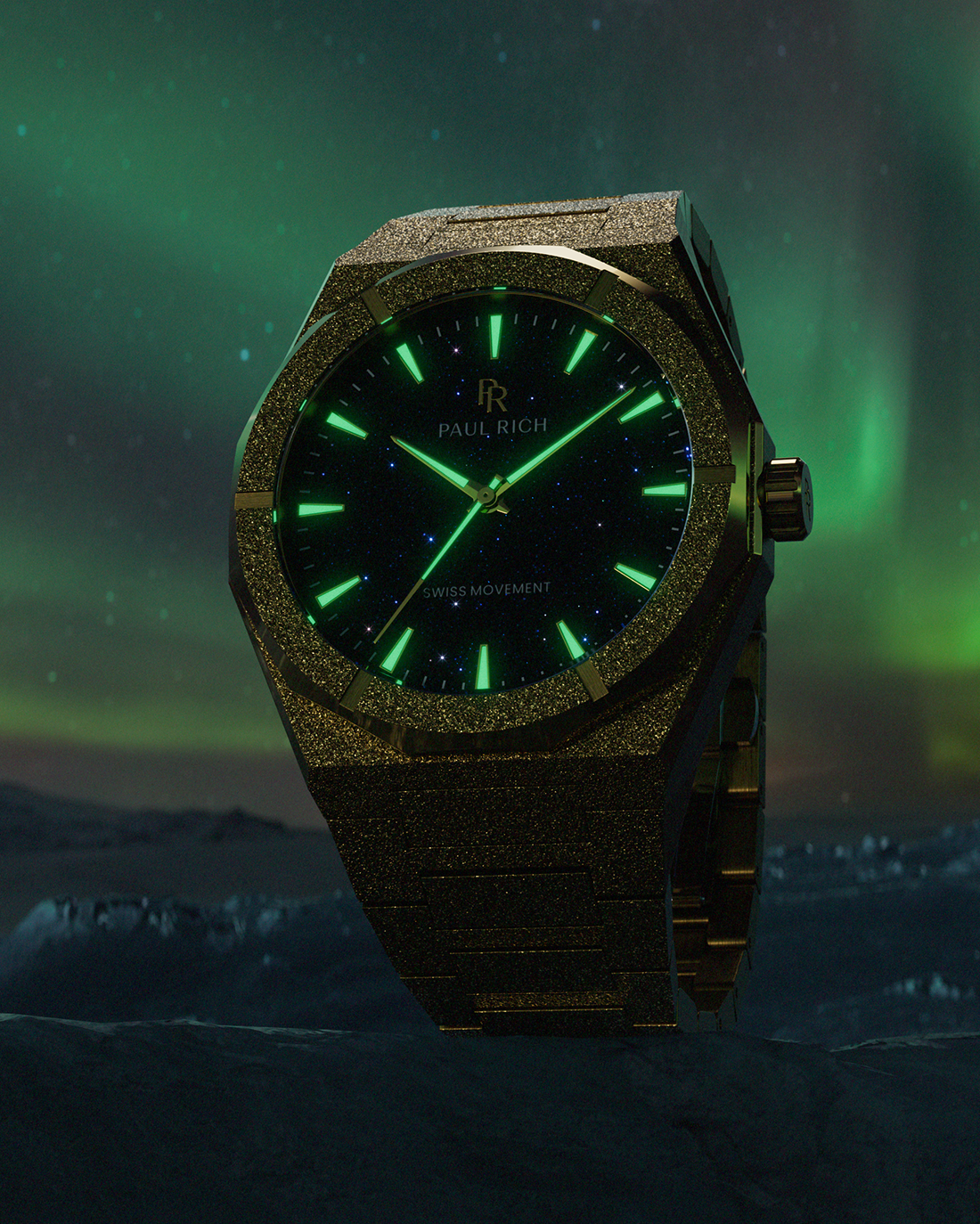 Paul Rich watch with frosted gold case and green-glowing markers over a black aventurine dial, set against the Northern Lights.