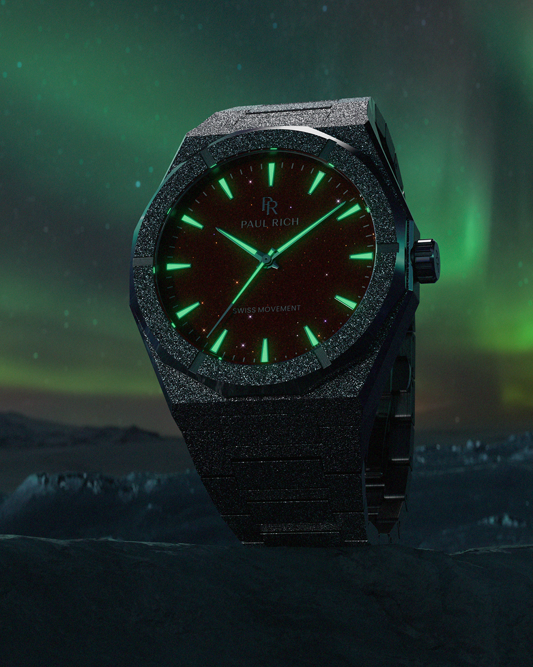 Paul Rich watch with frosted black case and glowing green markers over a red aventurine dial, set against an aurora-lit icy landscape.
