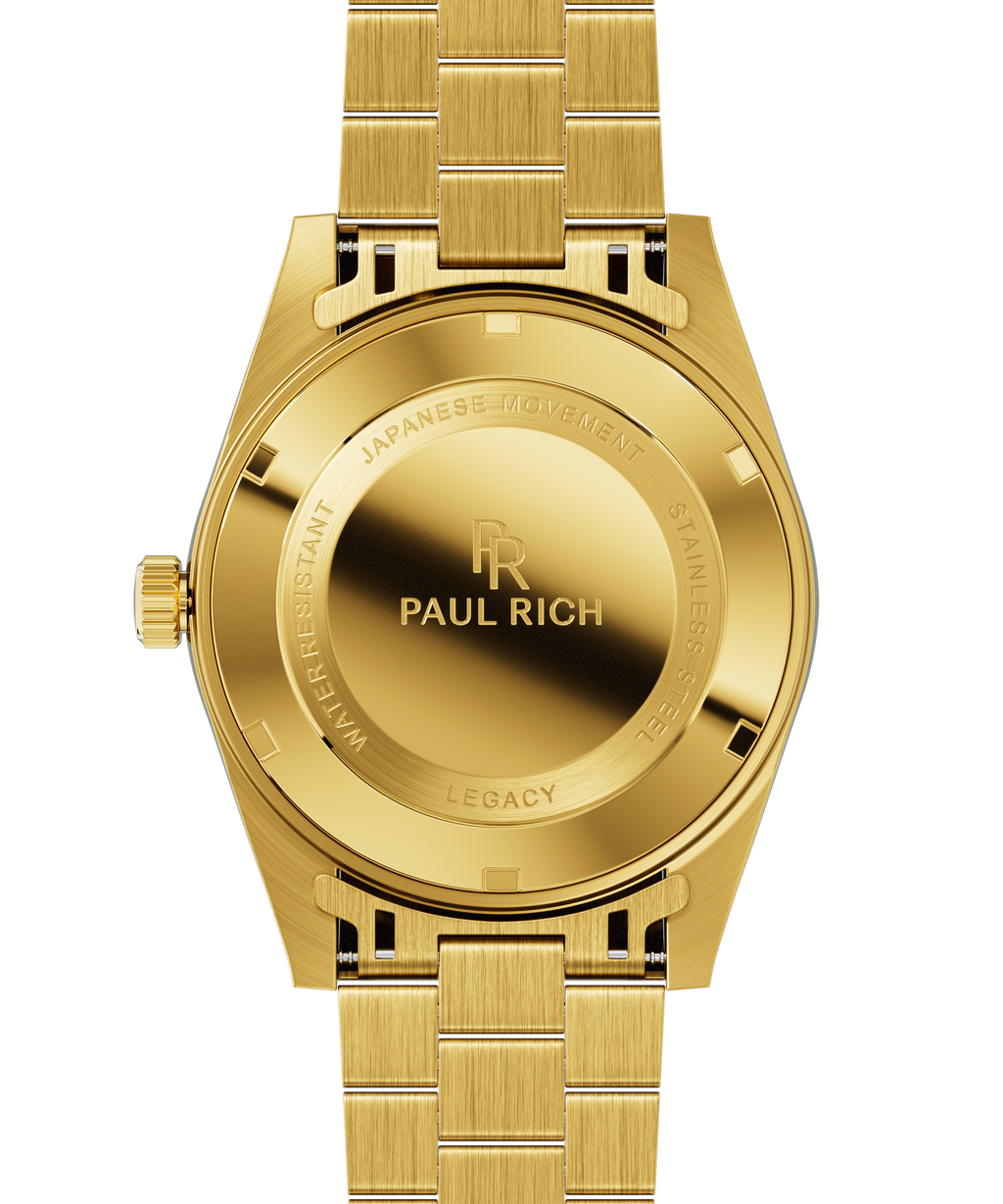 Back view of a gold wristwatch with brushed stainless steel case back engraved with Paul Rich branding and technical specifications.
