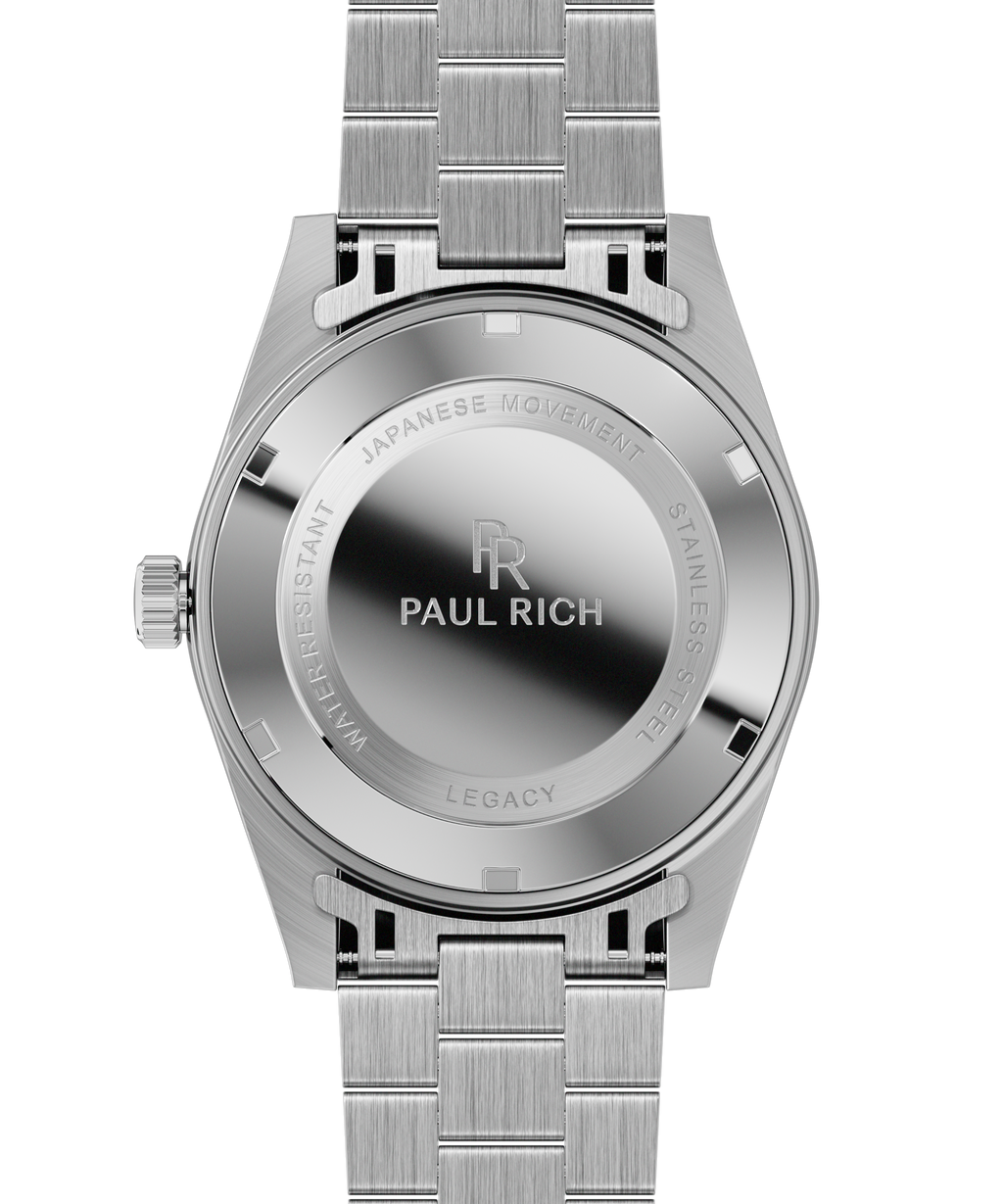 Back view of a silver Paul Rich watch showing a brushed stainless steel case back engraved with branding and product details.