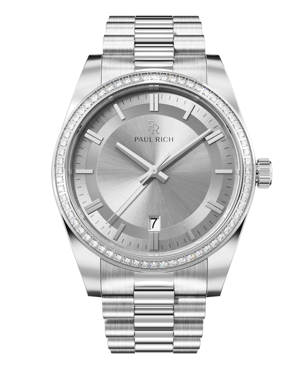 Front view of a silver-tone Paul Rich watch with silver sunray dial, diamond-set bezel, silver hour markers and hands, date display at 6 o'clock, and silver link bracelet.