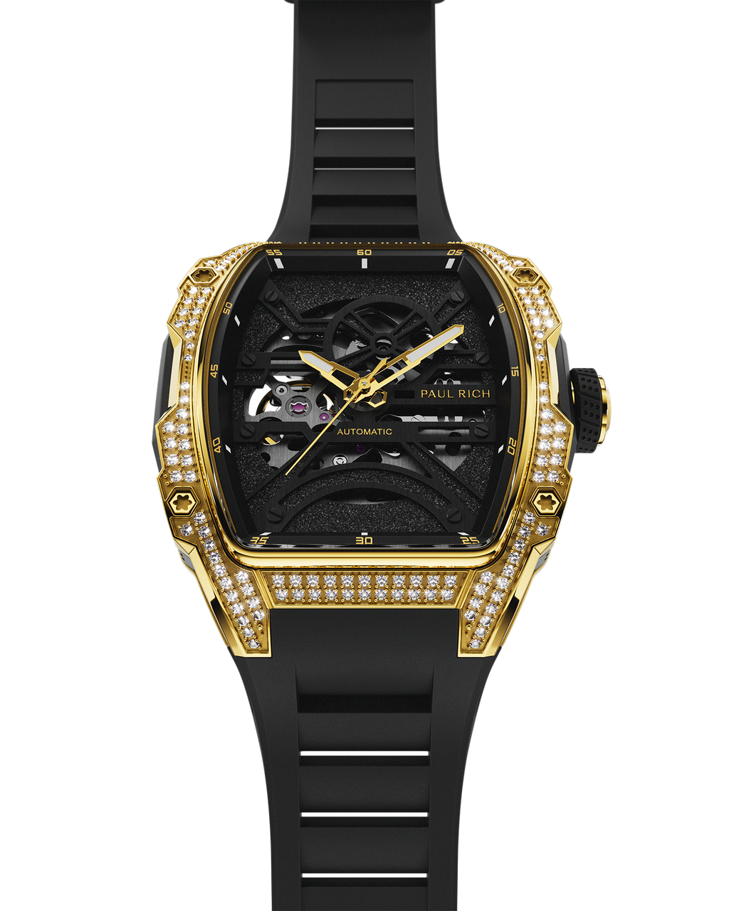 Gold tonneau-shaped wristwatch with skeleton dial, crystal-set bezel, black textured baseplate, and black rubber strap shown vertically on a transparent background.