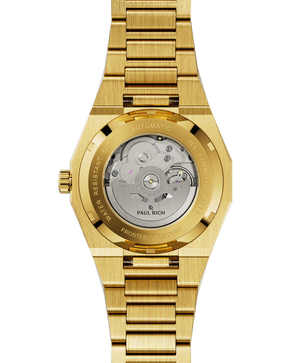 Gold watch caseback showing exposed automatic movement with “Paul Rich” logo and “Frosted Star Dust” engraved on the rim.