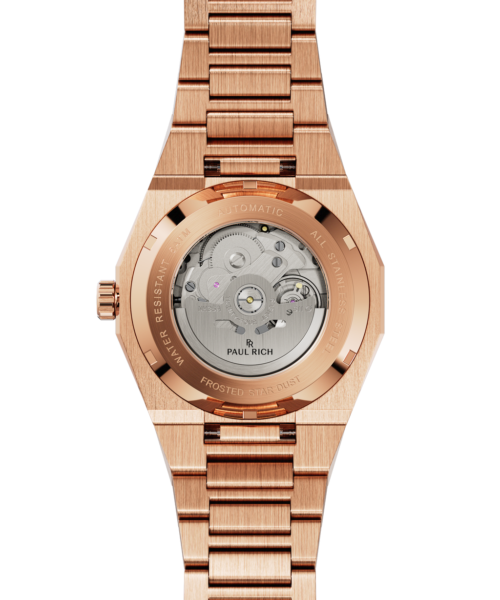 Back of rose gold Paul Rich watch with sapphire caseback showing automatic movement and “Frosted Star Dust” engraved on rim.