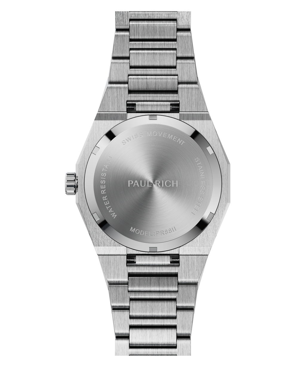 Back view of a silver wristwatch with a brushed stainless steel case back engraved with “Paul Rich,” “Swiss Movement,” and “Model: PR8II."